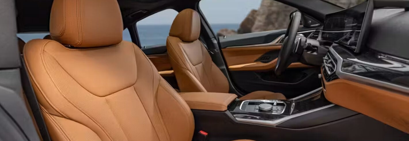 Interior shot showing upholstery details on BMW driver and passenger seats.